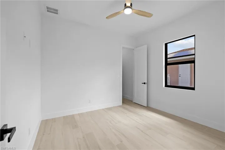 Unfurnished room with light wood finished floors and ceiling fan