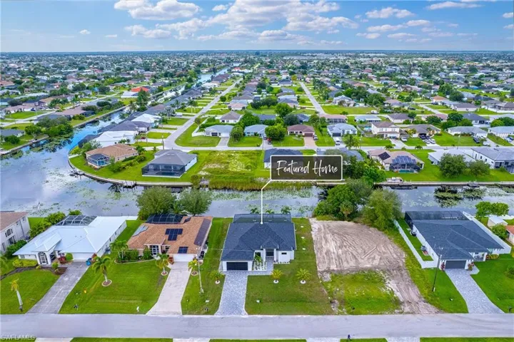 Aerial view of property's location featuring nearby suburban area