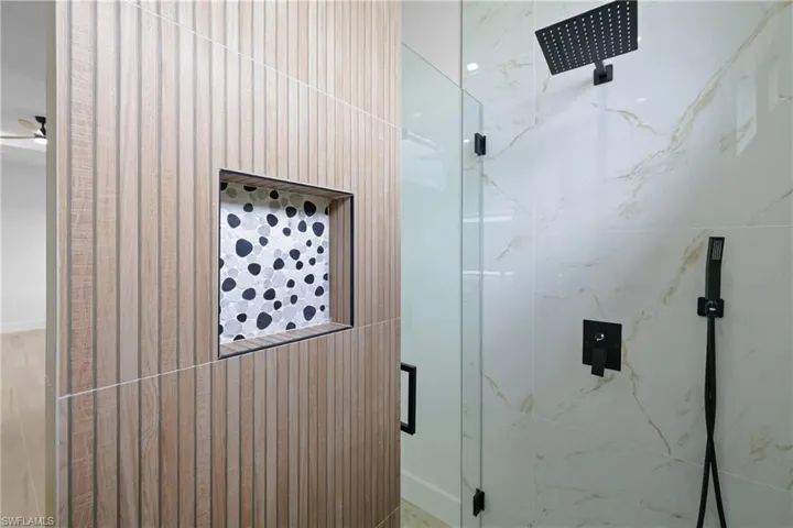 Bathroom with a marble finish shower