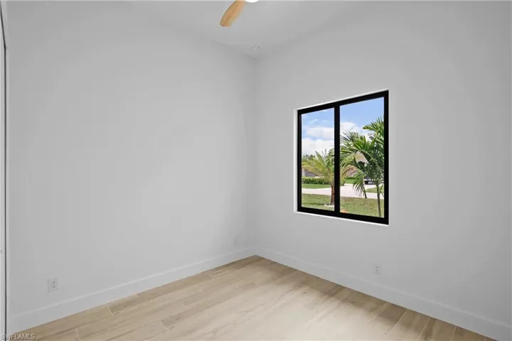 Empty room featuring light wood-style floors and ceiling fan