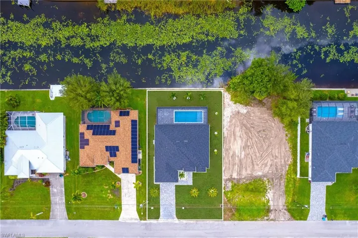 Aerial view of residential area featuring a pool
