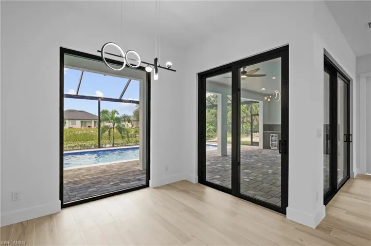Unfurnished dining area featuring a chandelier, light wood-style floors, and ceiling fan