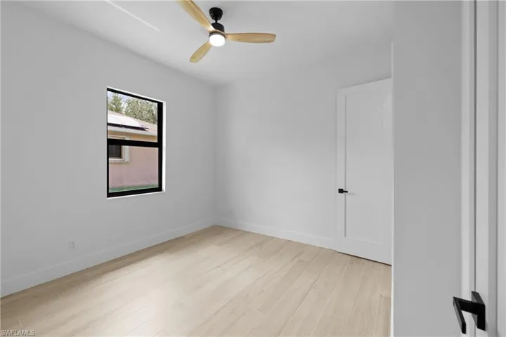 Spare room featuring light wood-style floors and a ceiling fan