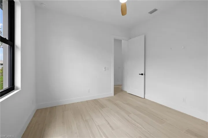Unfurnished room with light wood finished floors and a ceiling fan