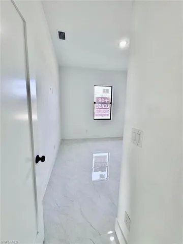Empty room featuring recessed lighting and baseboards