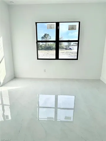 Spare room featuring baseboards