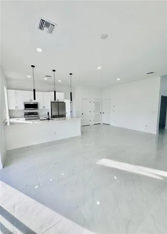 Unfurnished living room featuring recessed lighting