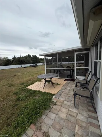 View of patio with a sunroom