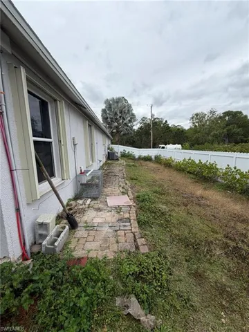 Fenced backyard with a patio area and entry steps