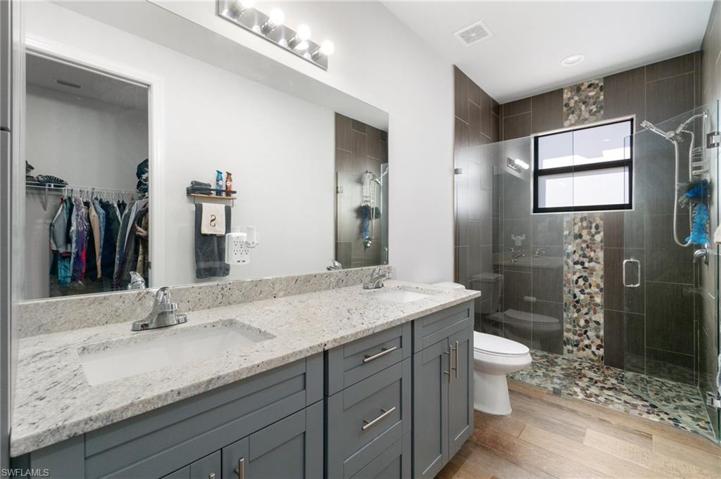 Primary bath boasting dual sinks, large shower and large walk-in closet.