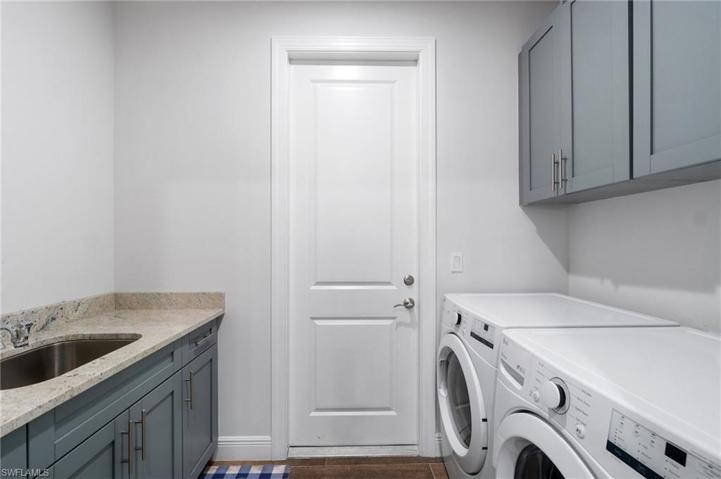 Laundry Room in residence with plenty of storage space and a utility sink.