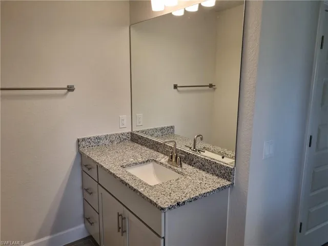 Bathroom featuring vanity and baseboards