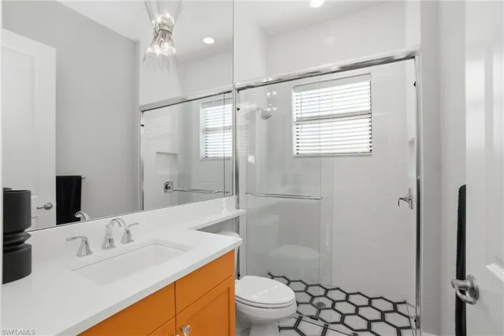 Full bathroom featuring vanity and a stall shower