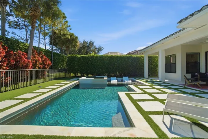 View of pool featuring a fenced backyard, a patio, and a pool with connected hot tub