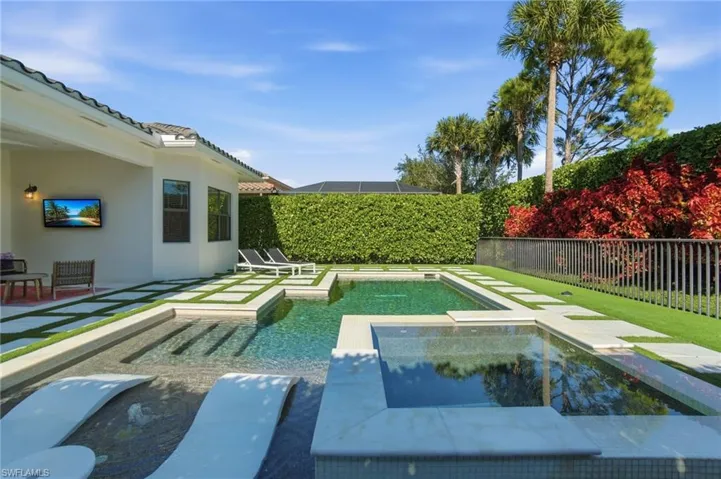 View of pool featuring a fenced backyard, a patio area, and a pool with connected hot tub
