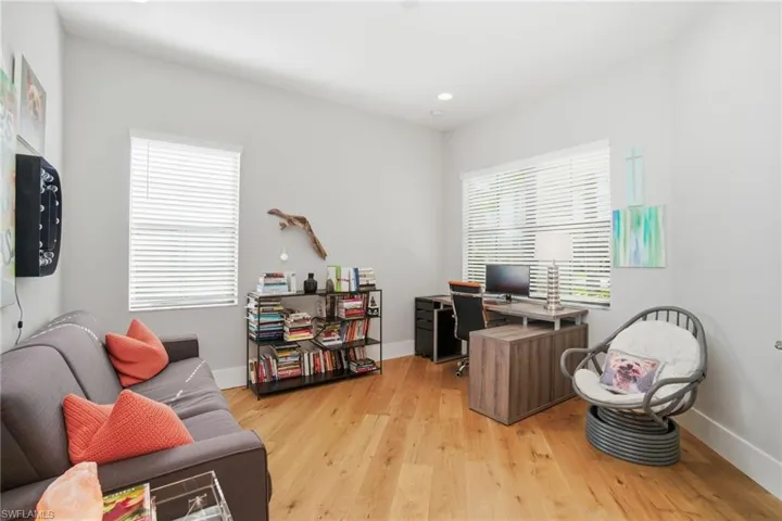Office with plenty of natural light, light wood-type flooring, and recessed lighting