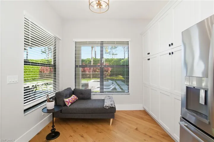 Living area with light wood finished floors and baseboards