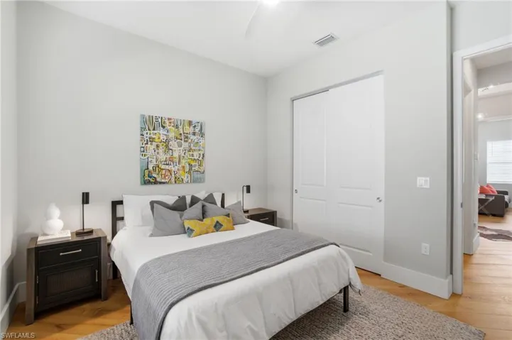 Bedroom with light wood-type flooring, a closet, and ceiling fan
