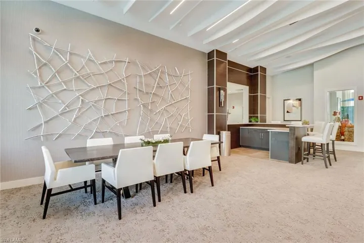 Dining space with baseboards and beam ceiling