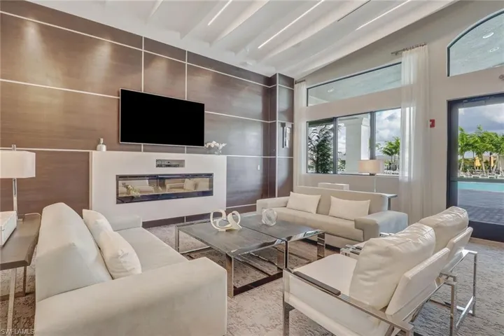 Living area with a glass covered fireplace and lofted ceiling