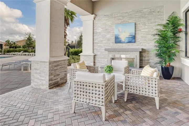 View of patio featuring a multi sided fireplace