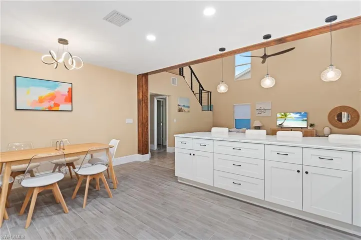 Kitchen featuring pendant lighting and white cabinetry