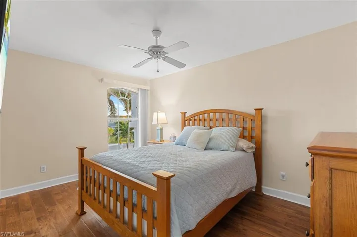 Bedroom featuring ceiling fan and dark wood-type flooring