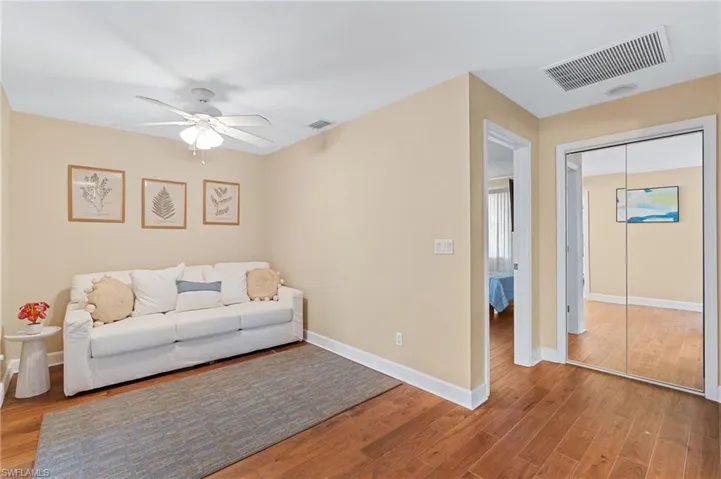 Living room featuring ceiling fan and wood-type flooring