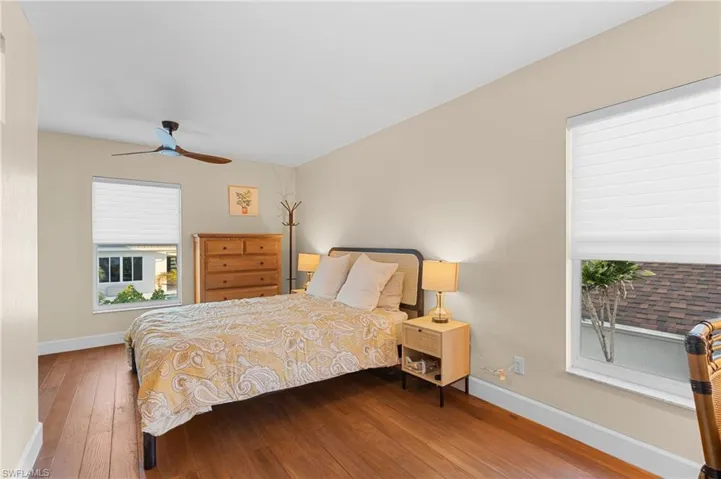 Bedroom featuring ceiling fan and hardwood / wood-style flooring