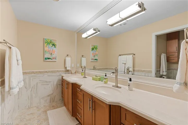 Bathroom featuring vanity and tile walls