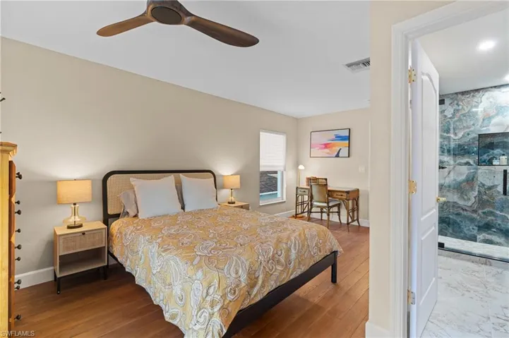 Bedroom featuring ceiling fan and wood-type flooring