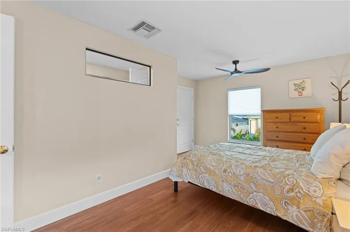 Bedroom with wood-type flooring and ceiling fan