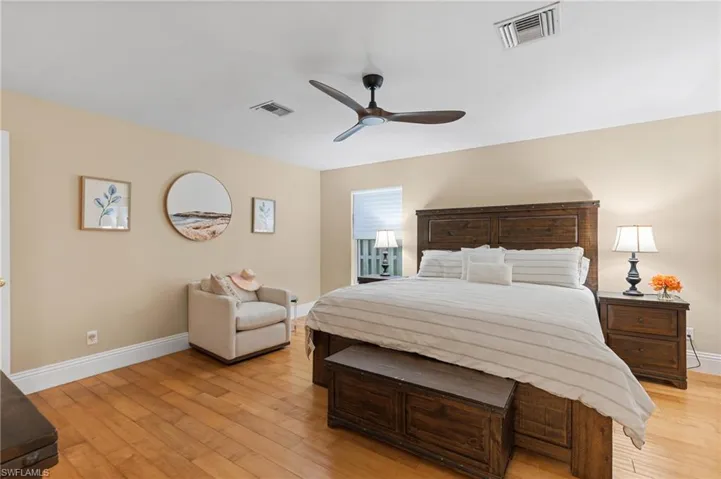 Bedroom with ceiling fan and light hardwood / wood-style floors