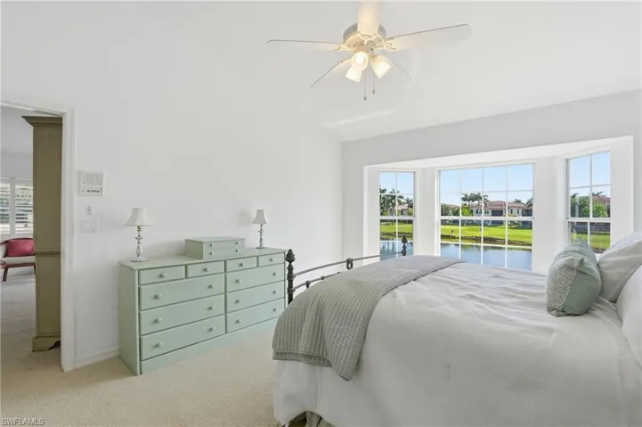 Spacious room featuring a multi-pane bay window overlooking a waterway