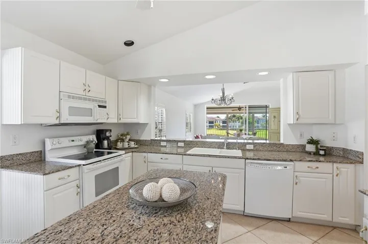 Kitchen featuring white cabinetry, stone-finish countertops, tile flooring, a built-in microwave, and an electric range