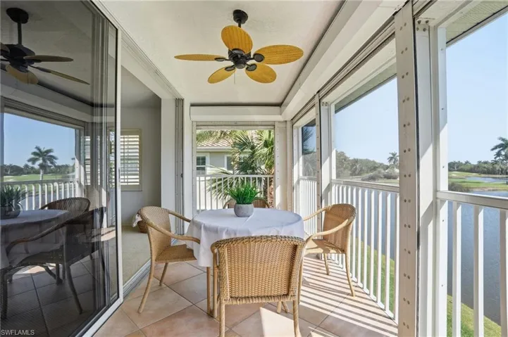 Enclosed patio with tile flooring and a ceiling fan