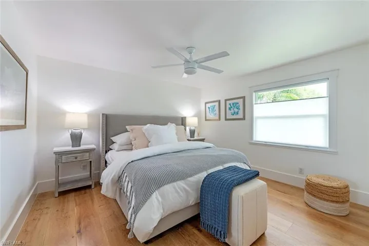 Bedroom featuring wood-type flooring and ceiling fan