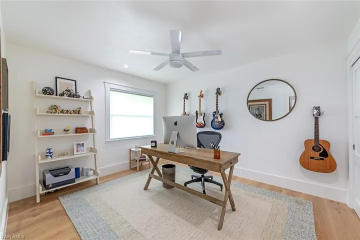 Office space featuring ceiling fan and light hardwood / wood-style flooring