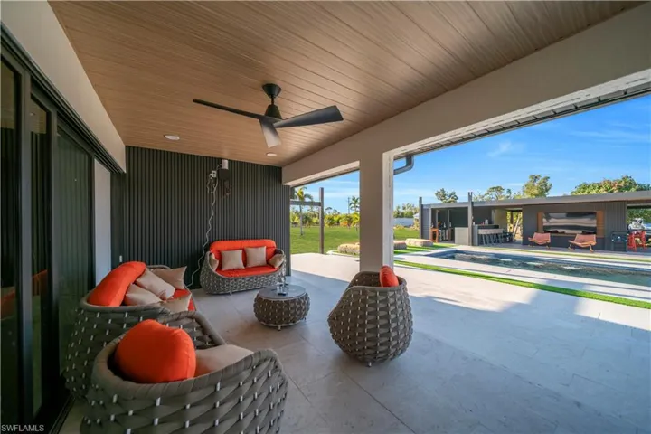 View of patio featuring an outdoor lounge area, ceiling fan, and an outdoor pool