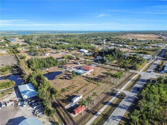 Aerial view of property and surrounding area with a large body of water