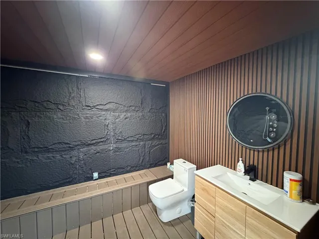 Bathroom featuring vanity, wood ceiling, and recessed lighting