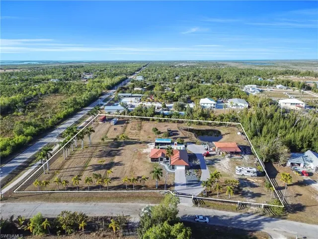 View of property location featuring a heavily wooded area and property boundaries highlighted
