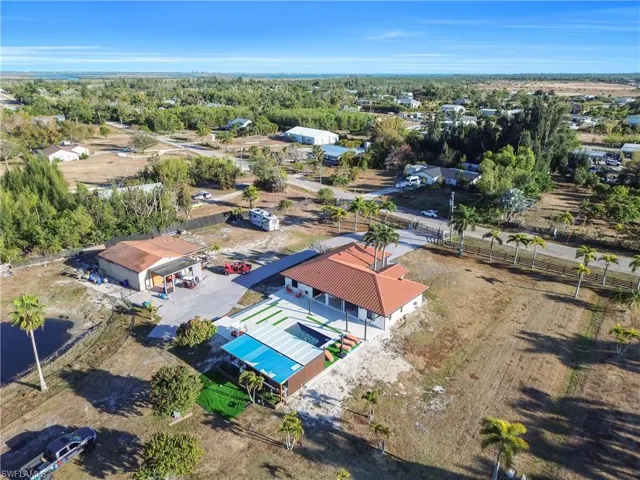 Aerial overview of property's location featuring a nearby body of water and nearby suburban area