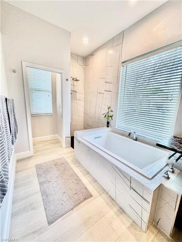 Primary bathroom w/tub and walk in shower