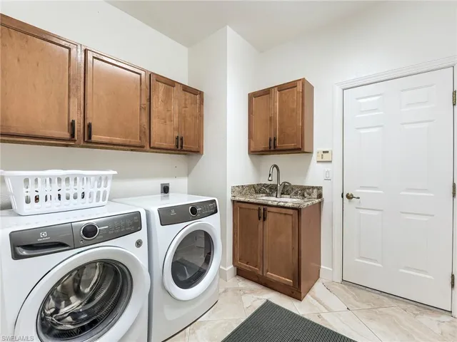 Laundry area with washing machine and clothes dryer and cabinet space