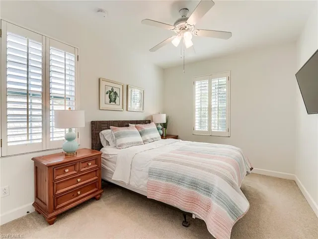 Guest bedroom 3, upstairs featuring light carpet and ceiling fan