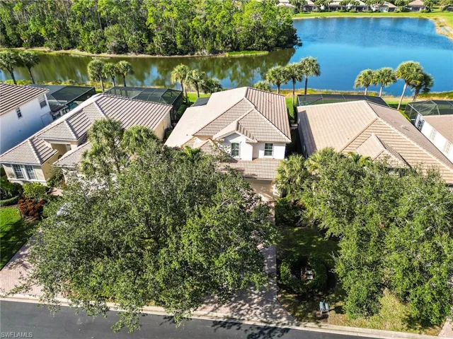 Aerial perspective of suburban area featuring a nearby body of water