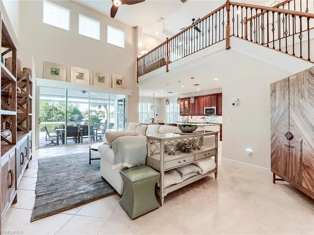 Living room featuring a ceiling fan and light tile patterned floors