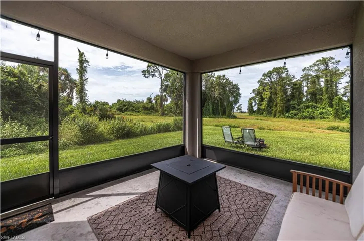 Unfurnished sunroom with view of scattered trees