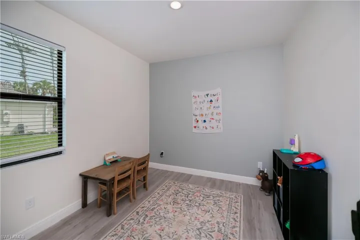Office with light wood-style flooring and baseboards